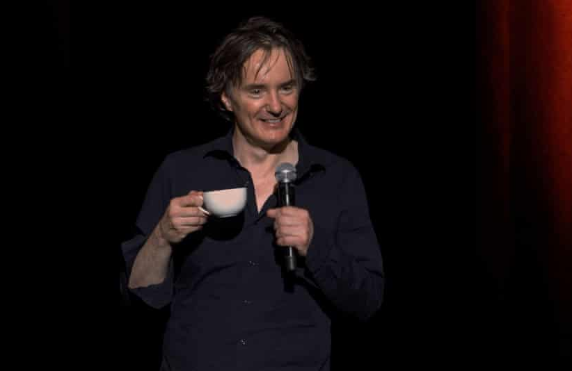 DYLAN MORAN STANDUP with microphone and teacup Blank Meme Template