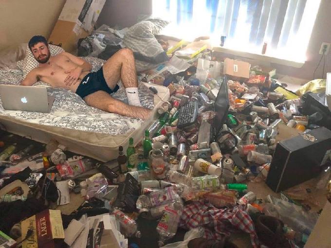 Guy in messy room surrounded by trash Blank Meme Template