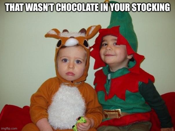 Mischievous Elf with Reindeer | THAT WASN’T CHOCOLATE IN YOUR STOCKING | image tagged in christmas elf boy reindeer baby,christmas,reindeer,baby,angry baby,mischievous | made w/ Imgflip meme maker