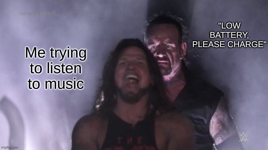 best title you've ever seen in the history of ever | "LOW BATTERY, PLEASE CHARGE"; Me trying to listen to music | image tagged in aj styles undertaker | made w/ Imgflip meme maker