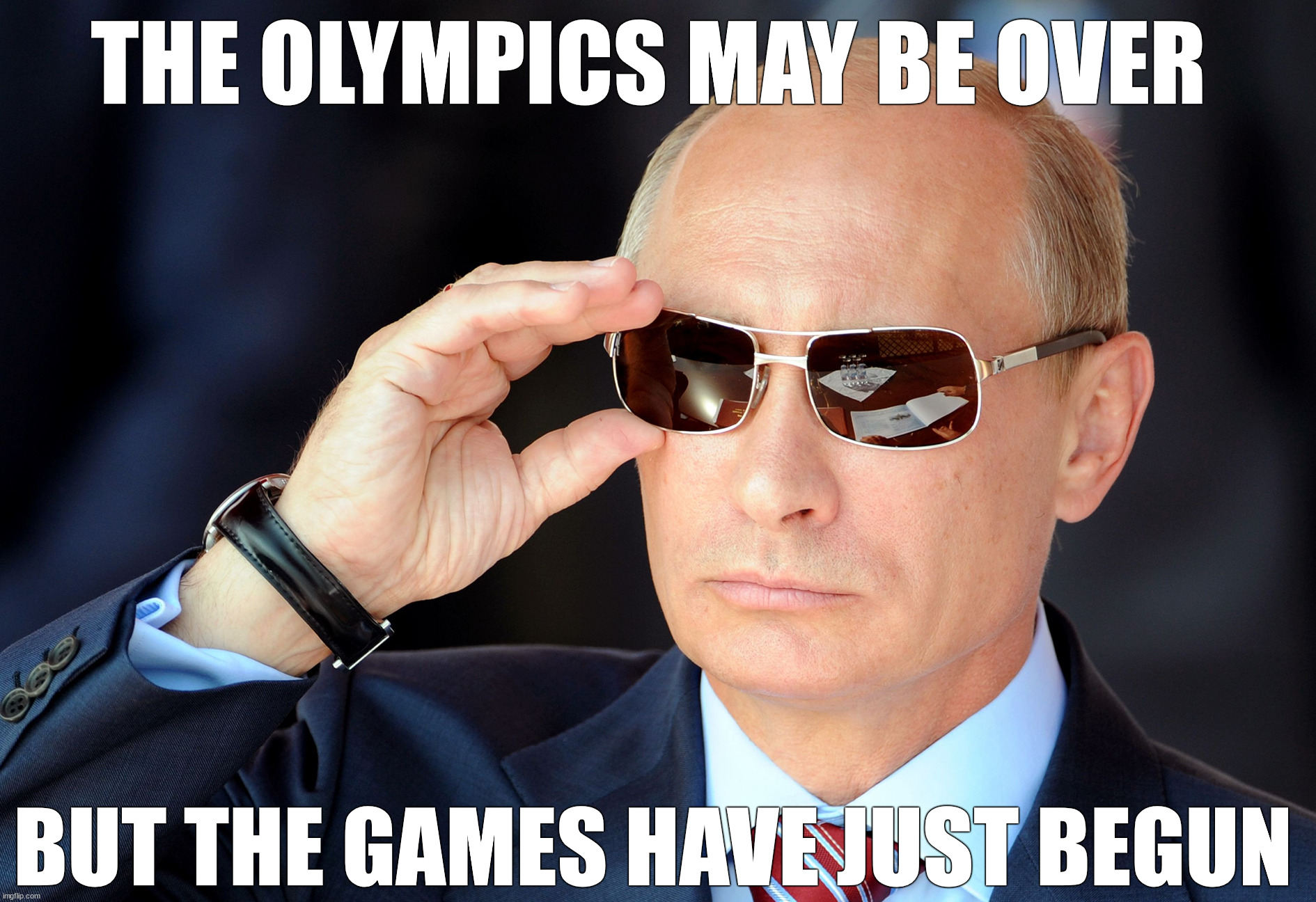 Russian Prime Minister Vladimir Putin adjusts his cool sunglasses at Airshow AUG2011 | THE OLYMPICS MAY BE OVER; BUT THE GAMES HAVE JUST BEGUN | image tagged in russia,vladimir putin,winter olympics,2022,ukraine,ww3 | made w/ Imgflip meme maker