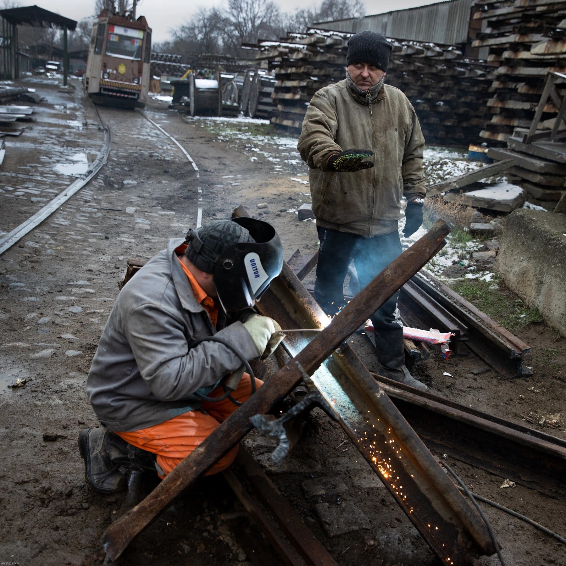 Ukrainians welding barricades to impede the Russian invasion. | image tagged in ukrainian welders | made w/ Imgflip meme maker