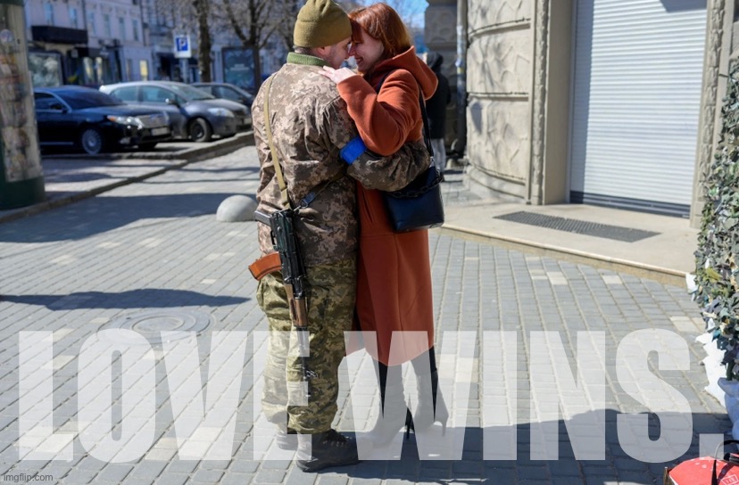 A Ukrainian soldier embraces his wife in the center of Odessa on March 17, 2022. | LOVE WINS. | image tagged in ukrainian soldier hugs wife | made w/ Imgflip meme maker