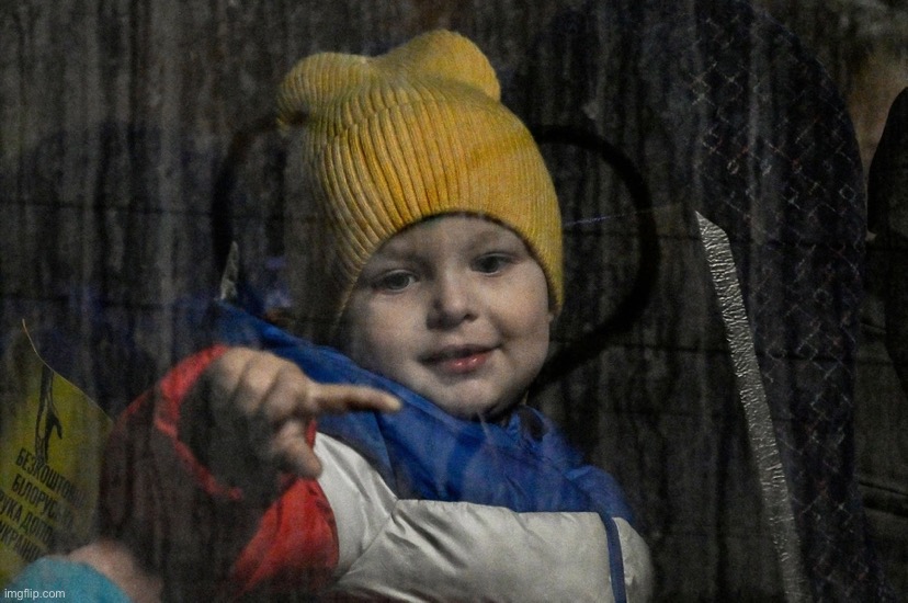 A child traces the lines of a heart drawn by a Polish volunteer on the window of a bus after crossing the border — 3/14/2022. | image tagged in ukrainian child refugee | made w/ Imgflip meme maker
