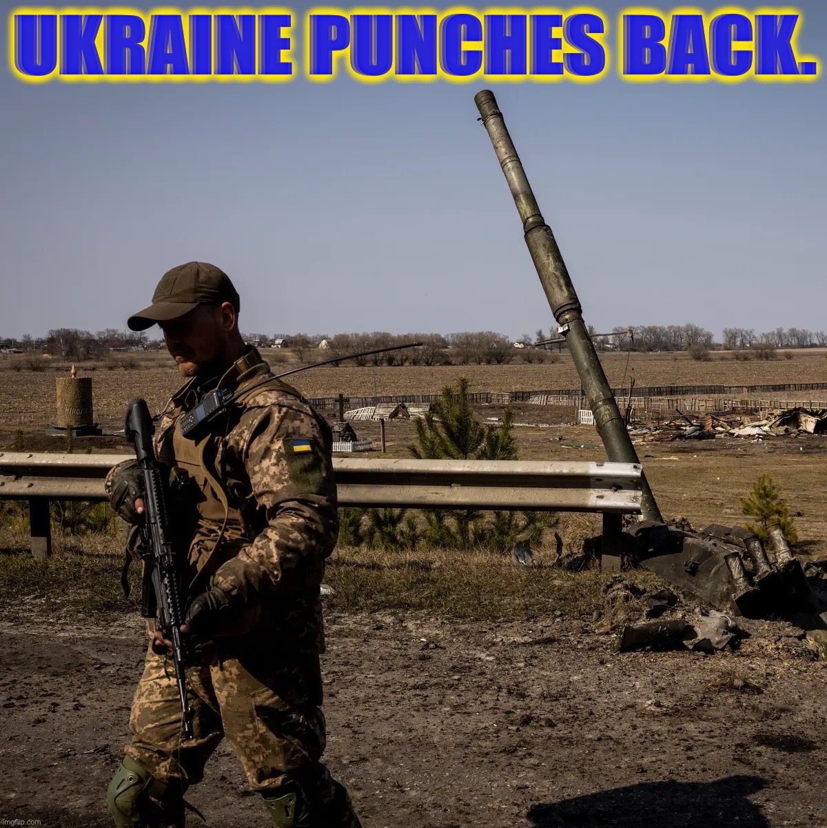 A Ukrainian soldier patrols near the remnants of a Russian T-90 tank, destroyed by a U.S.-made Javelin missile. | UKRAINE PUNCHES BACK. | image tagged in ukrainian soldier | made w/ Imgflip meme maker