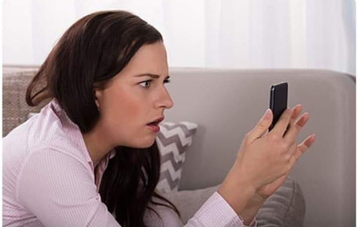 High Quality STARTLED WOMAN, WOMAN SHOCKED AT NEWS ON PHONE Blank Meme Template