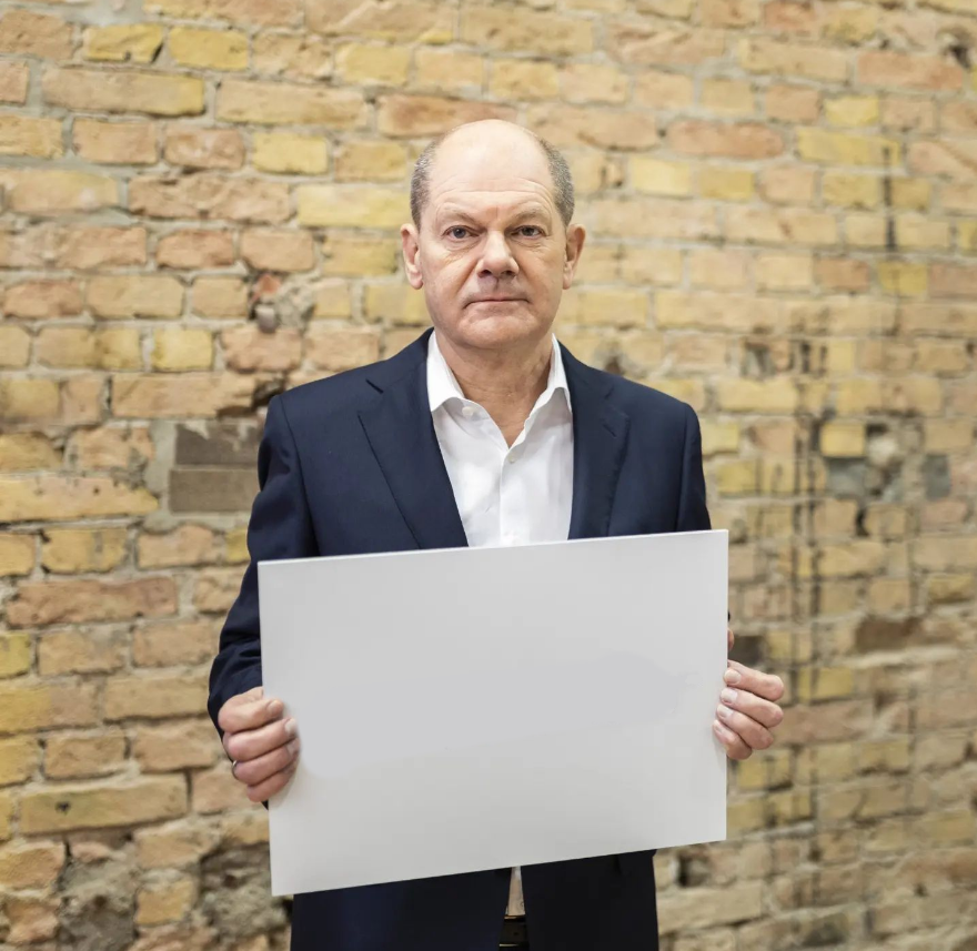 Olaf Scholz holds up a sign Blank Meme Template