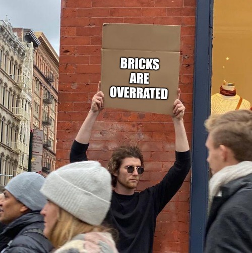 I am NOT John Lennon | BRICKS ARE OVERRATED | image tagged in memes,guy holding cardboard sign,bricks | made w/ Imgflip meme maker