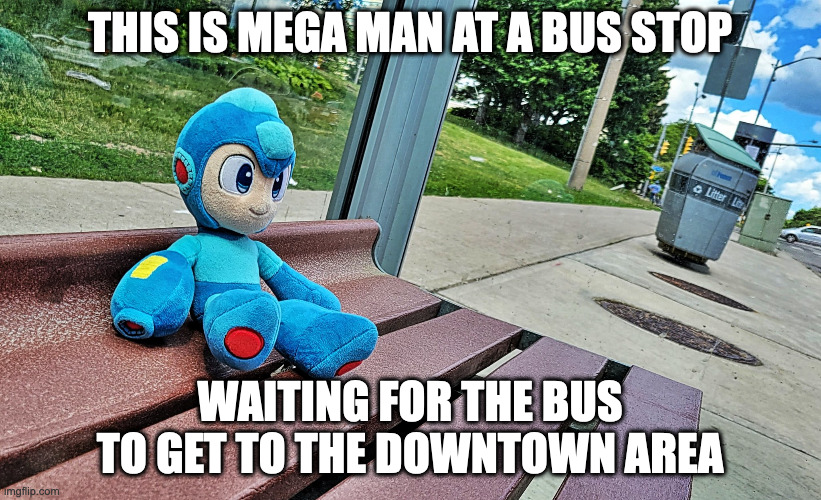 Mega Man on a Bench | THIS IS MEGA MAN AT A BUS STOP; WAITING FOR THE BUS TO GET TO THE DOWNTOWN AREA | image tagged in megaman,memes | made w/ Imgflip meme maker