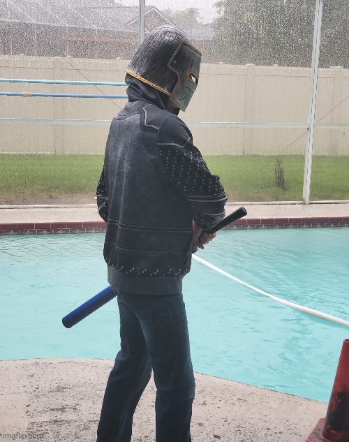 A picture of me in the rain holding a training sword | image tagged in face reveal when i hit 90 followers | made w/ Imgflip meme maker
