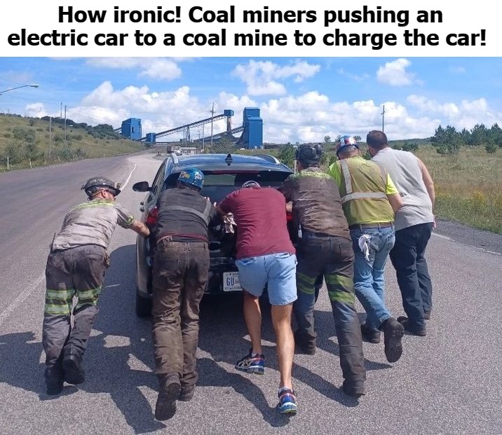 Coal miners pushing an electric car to a coal mine to charge the car