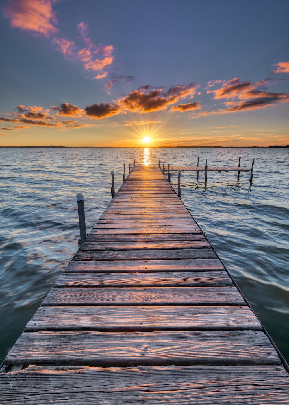 Sun set behind a long dock Blank Meme Template