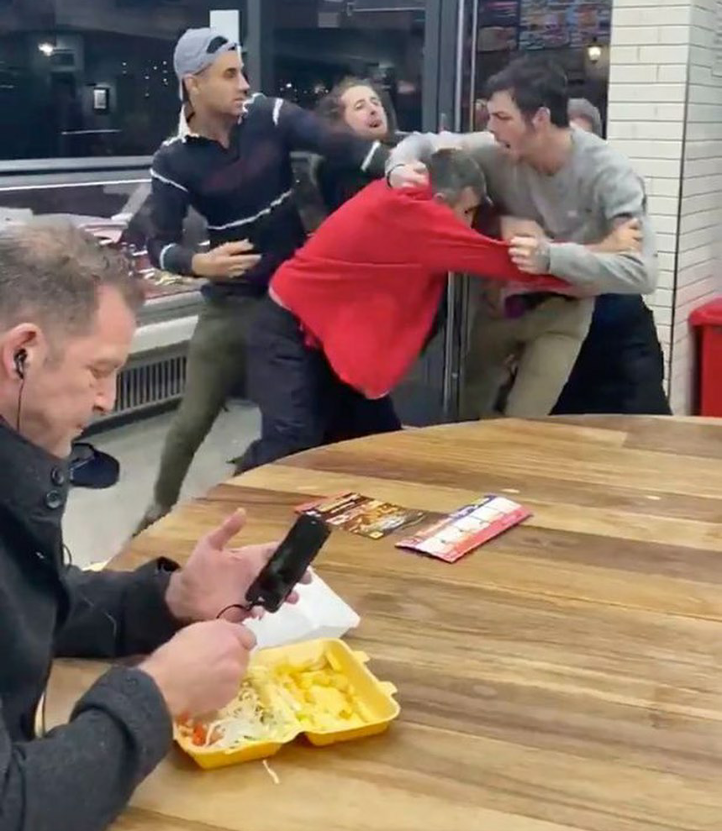 High Quality Dude casually eating next to a group fight Blank Meme Template