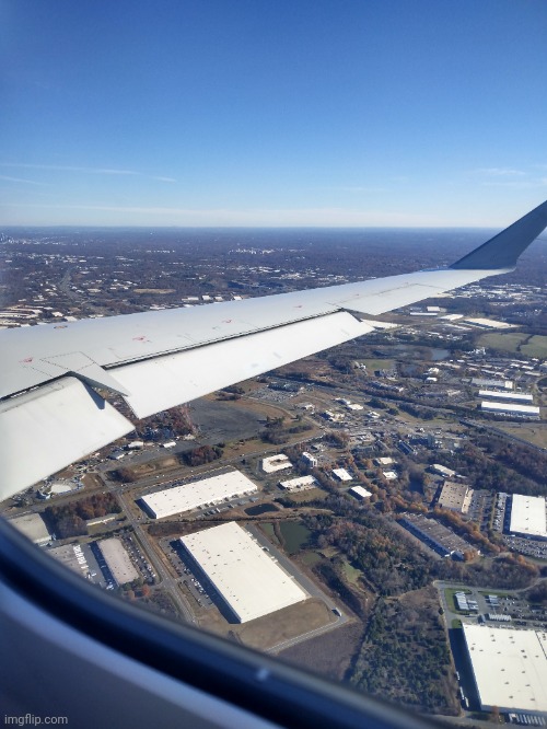 The view out the window from the very back seat of a CRJ 900 on approach into Charlotte | image tagged in airplane,window,charlotte | made w/ Imgflip meme maker