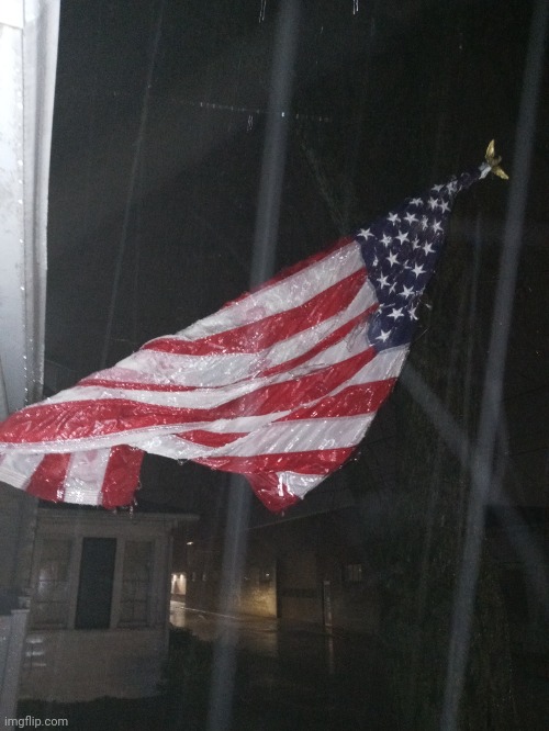 MY FLAG IS COMPLETELY FROZEN IN THIS ICE RAIN | image tagged in american flag,ice | made w/ Imgflip meme maker
