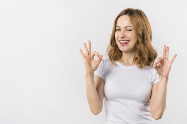 young woman biting her tongue showing ok gesture with two hands- Blank Meme Template