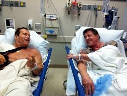 Schwarzenegger and Stallone hospital bed Blank Meme Template
