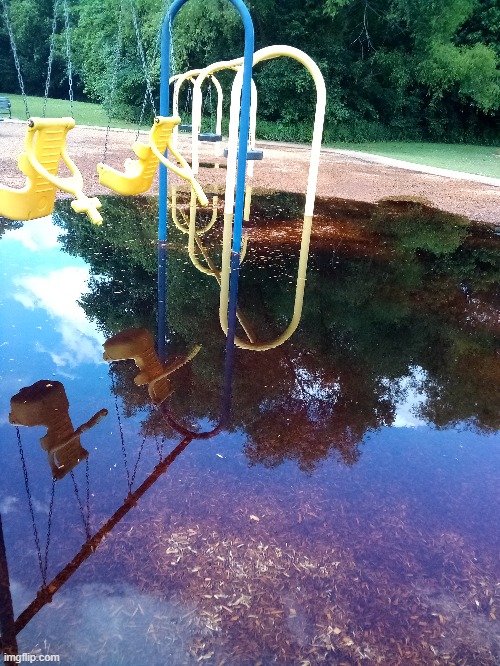 Really big puddle at a playground | image tagged in photo | made w/ Imgflip meme maker