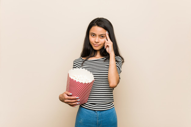 Young Woman with a bucket of popcorn. Blank Meme Template