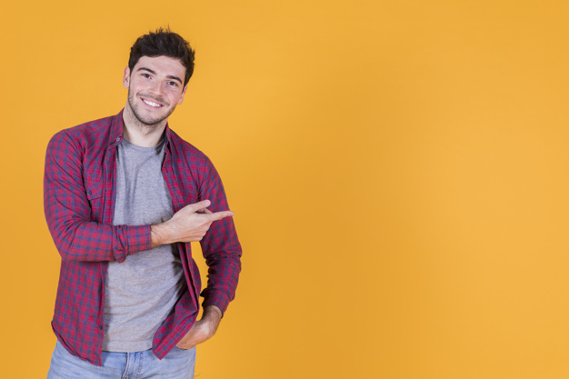 Smiling young man against a yellow backdrop Blank Meme Template