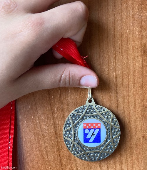 Image of a karate bronze medal I won 2 hours ago (extra hand reveal lol) | made w/ Imgflip meme maker