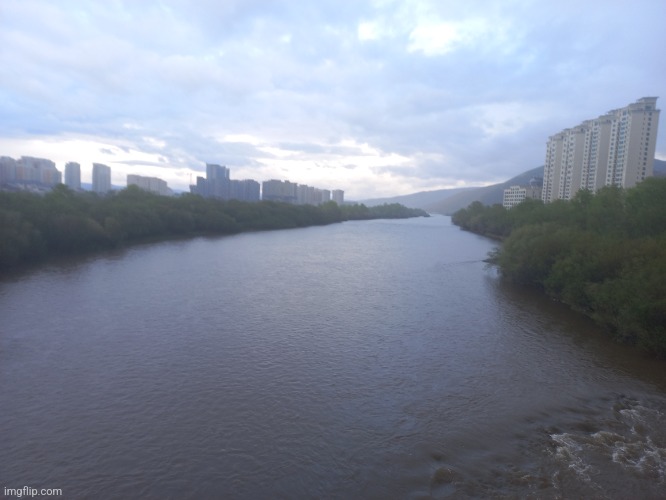 A nice flow of river accompanied by buildings and sky box | made w/ Imgflip meme maker