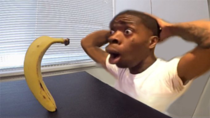 Shocked black guy staring into a banana Blank Meme Template