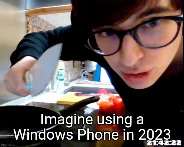 Spanish guy with knife | Imagine using a Windows Phone in 2023 | image tagged in spanish guy with knife | made w/ Imgflip meme maker