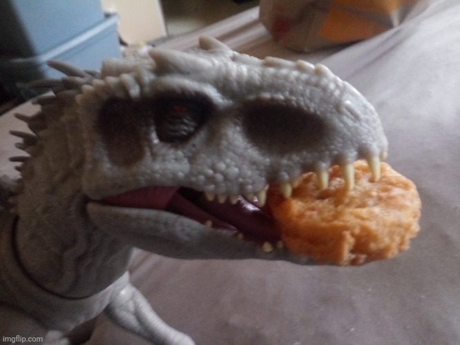 Indominus Rex eating a chicken nugget from McDonald's | image tagged in jurassic park,jurassic world | made w/ Imgflip meme maker