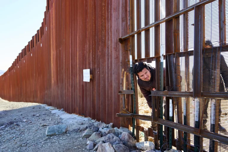 illegal alien peeking through border wall Blank Meme Template