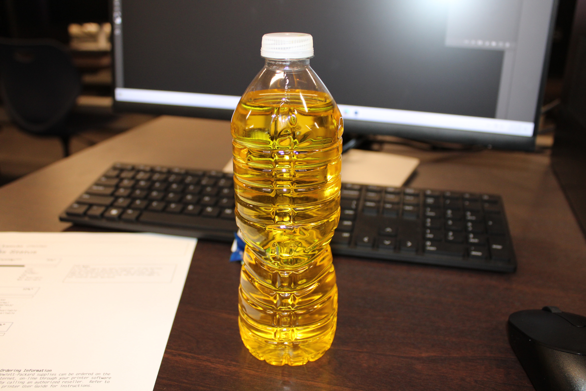 Yellow water bottle on desk Blank Meme Template