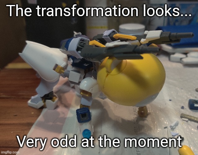 I tried to make it look like a cat but doing that with a Gundam is difficult | The transformation looks... Very odd at the moment | made w/ Imgflip meme maker