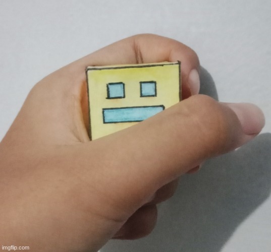 Geometry Dash paper cube being held | image tagged in geometry dash paper cube being held | made w/ Imgflip meme maker