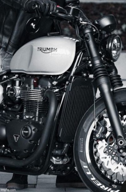 Triumph. | image tagged in motorcycle,biker,triumph,bike,ride,alone on the streets | made w/ Imgflip meme maker