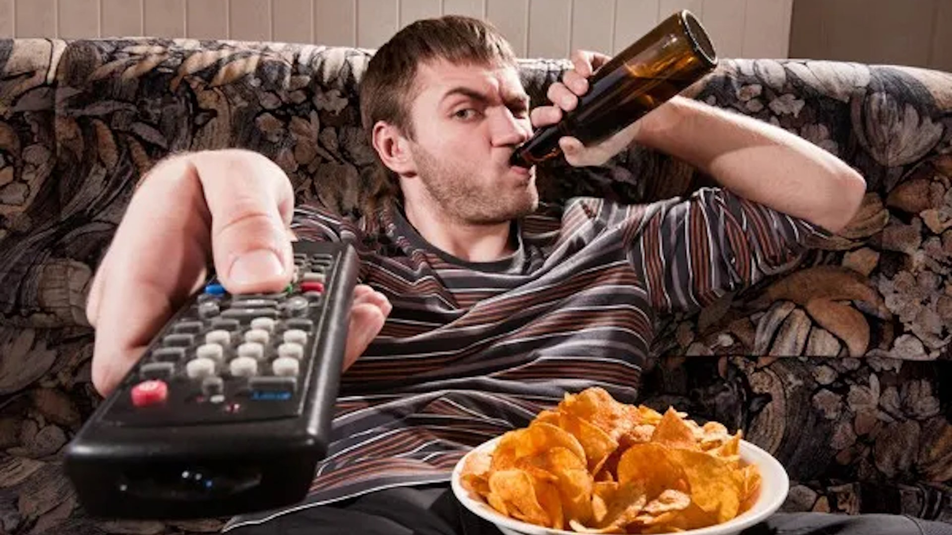 Man with beer and chips watching TV at home Blank Meme Template