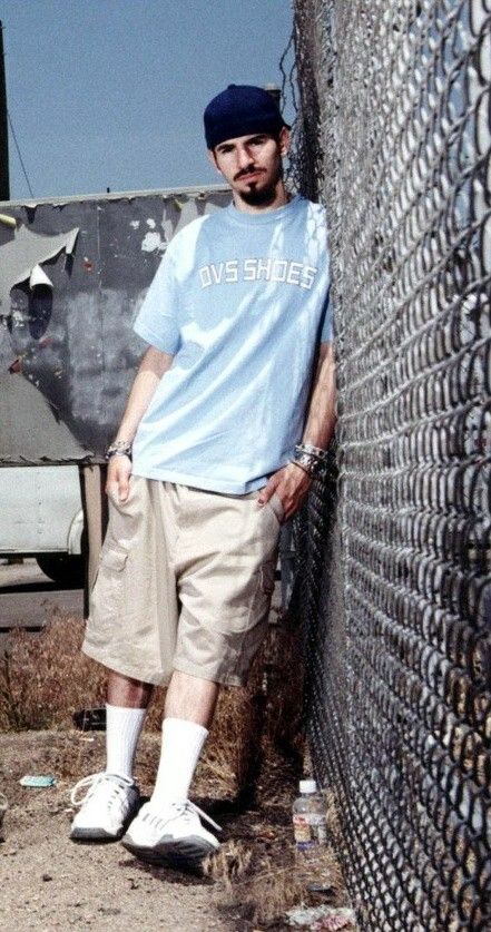Brad Delson against a fence Blank Meme Template