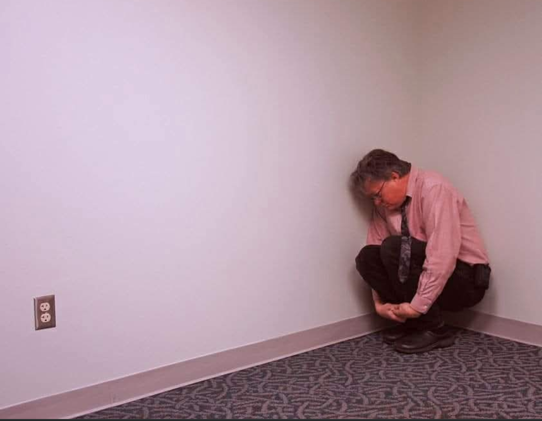 Man huddled in room corner Blank Meme Template