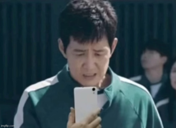 Seong Gi-Hun looking at his phone | image tagged in seong gi-hun looking at his phone | made w/ Imgflip meme maker