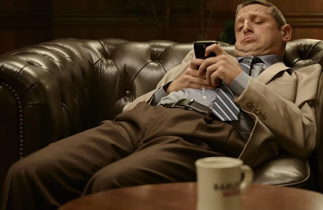 On phone on couch Blank Meme Template