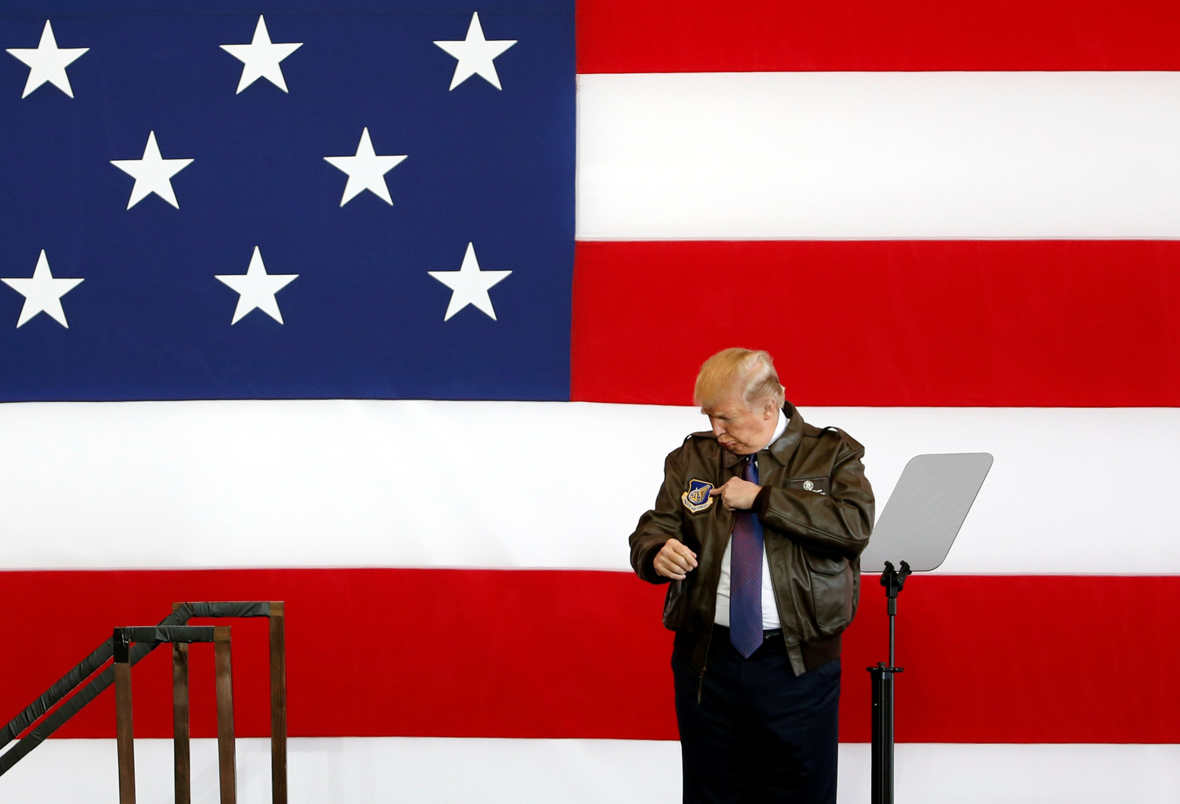 trump low iq stands in front of flag Blank Meme Template