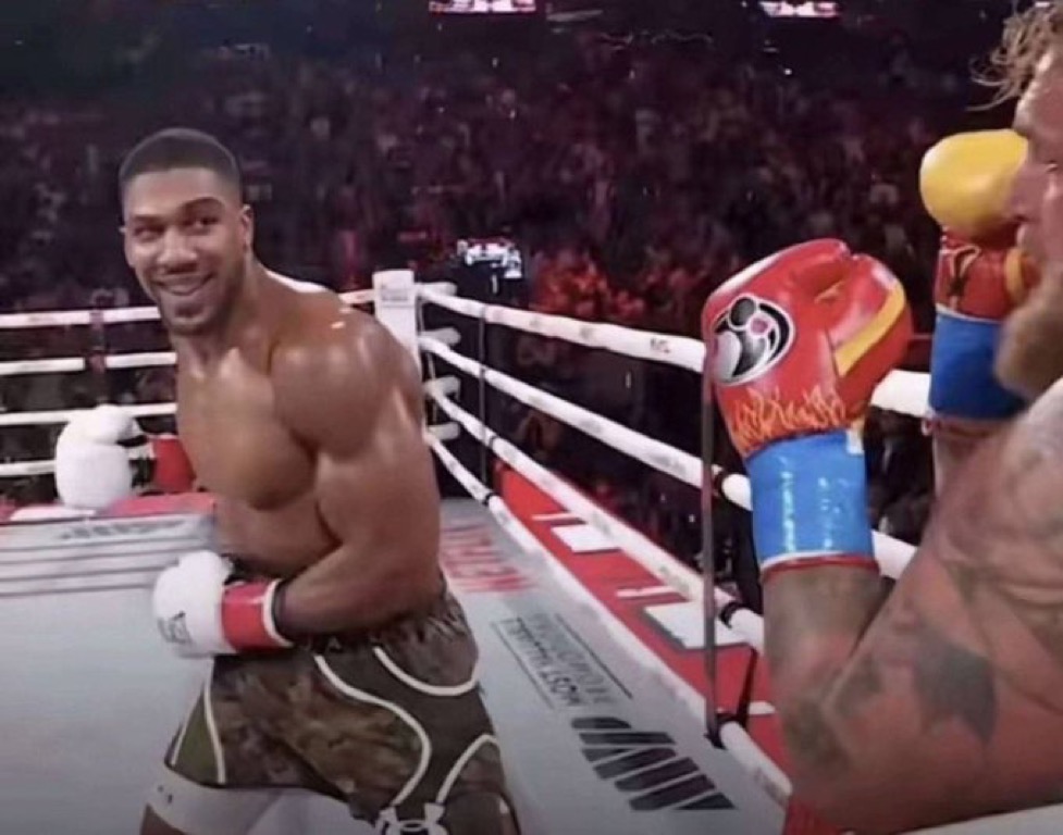 Anthony Joshua smiling while knocking out Jake Paul Blank Meme Template