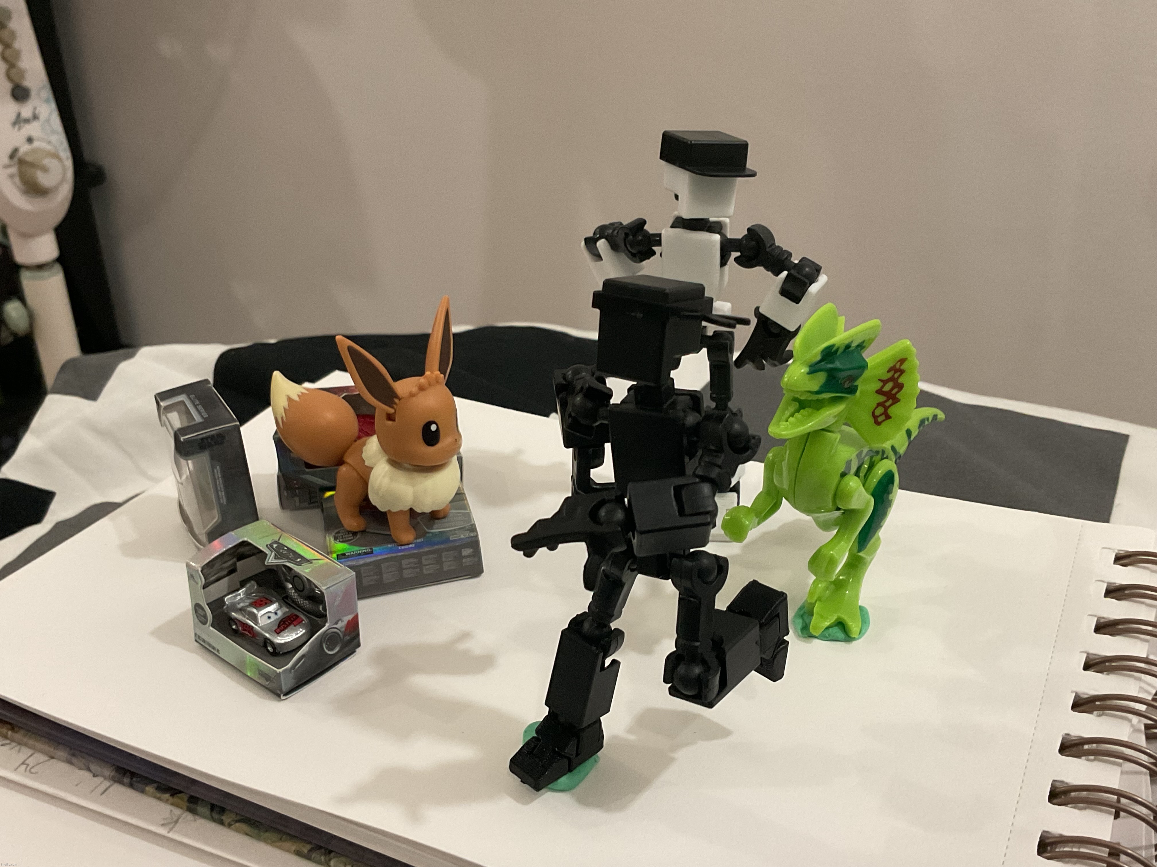 I got a new Dilophosaurus figure, sticky tack (to make them balance), and limited edition Disney Mini Brands | image tagged in stuff,shiro and kuro,dinosaur | made w/ Imgflip meme maker