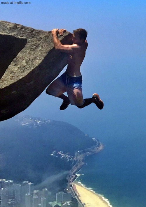 Man Hanging from a Cliff | image tagged in man hanging from a cliff | made w/ Imgflip meme maker