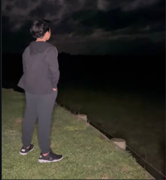 A boy standing by the riverside at night, lost in deep thoughts Blank Meme Template