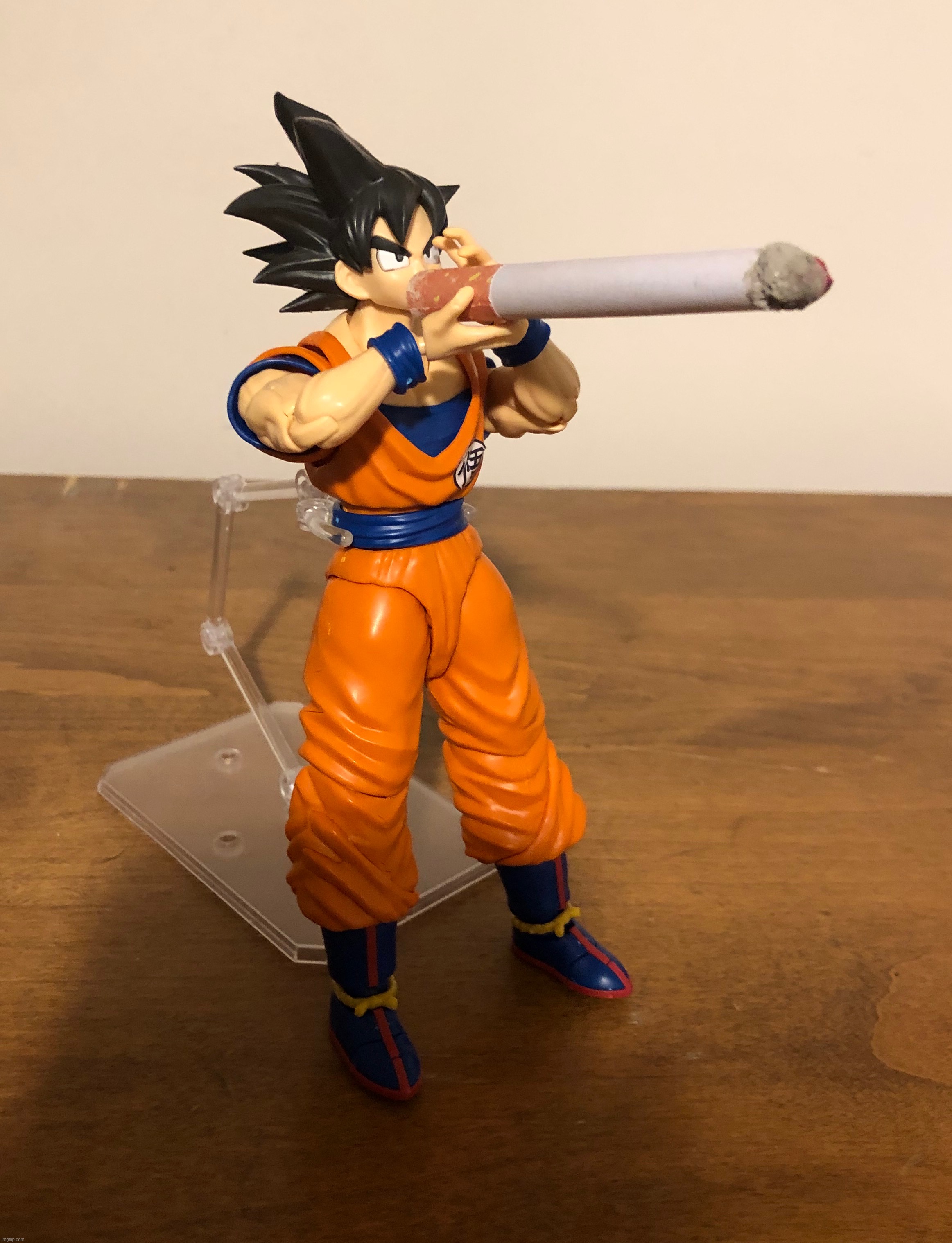 Goku has to take a quick hit to reach Super Saiyan 5 (my dad was messing with my action figure, resulting in this) | image tagged in goku,dragon ball,doobie,fat blunt,that is a fake cigarette btw,super saiyan | made w/ Imgflip meme maker