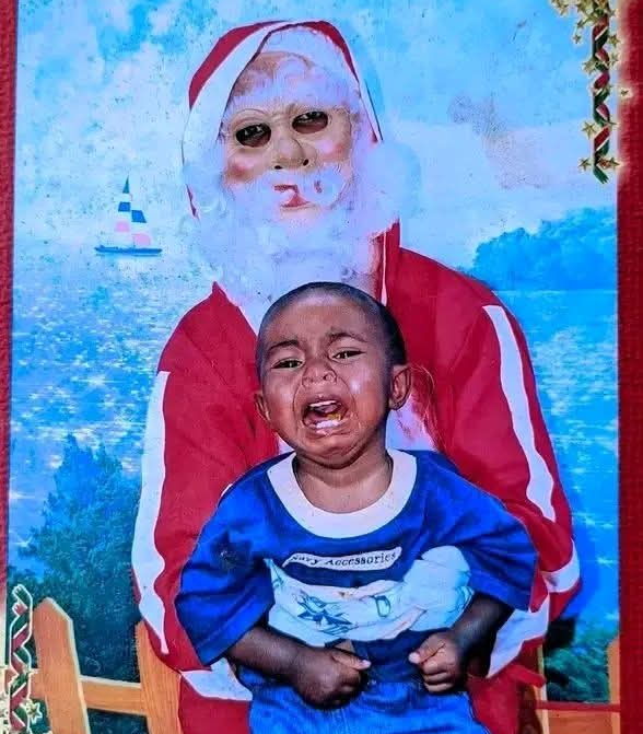 Creepy Santa holding a crying child Blank Meme Template
