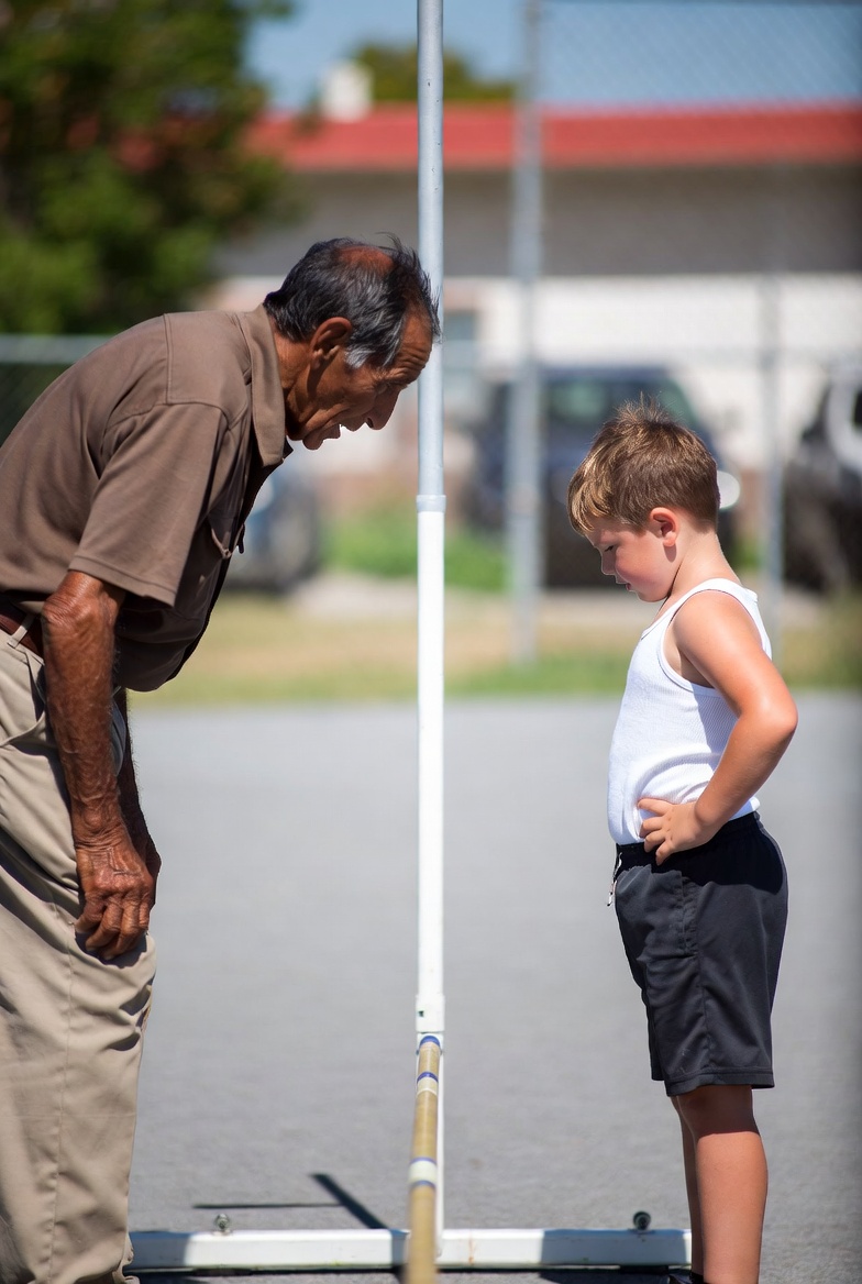 Old man and young white boy  looking at lowbar high bar Blank Meme Template