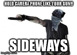 HOLD CAMERA PHONE LIKE YOUR GUN!! SIDEWAYS | image tagged in phone/gun | made w/ Imgflip meme maker