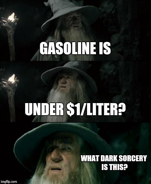 Confused Gandalf | GASOLINE IS UNDER $1/LITER? WHAT DARK SORCERY IS THIS? | image tagged in memes,confused gandalf | made w/ Imgflip meme maker