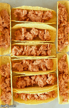 Ground Turkey Tacos that are oven-baked with layers of deliciousness inside! Refried beans, ground turkey taco meat, (no taco seasoning mix!) tomato, cilantro, green onions and cheese all baked in taco shells.